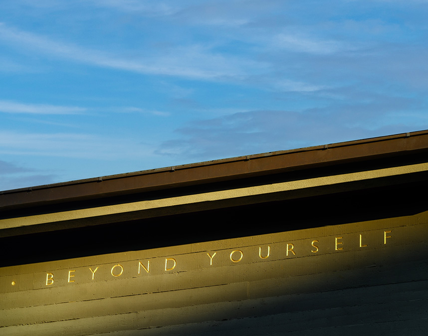 Image of building on campus with words "Beyond Yourself" inscribed on it.